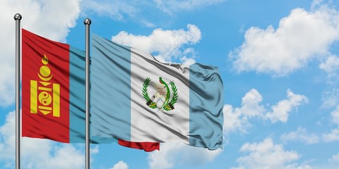 Mongolia and Guatemala flag waving in the wind against white cloudy blue sky together. Diplomacy concept, international relations.