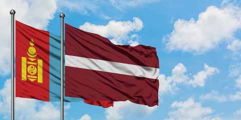 Mongolia and Latvia flag waving in the wind against white cloudy blue sky together. Diplomacy concept, international relations.