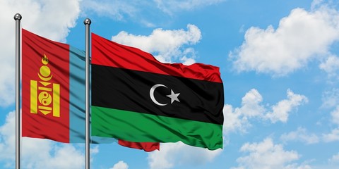 Mongolia and Libya flag waving in the wind against white cloudy blue sky together. Diplomacy concept, international relations.