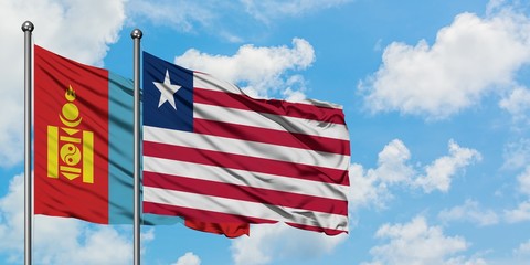 Mongolia and Liberia flag waving in the wind against white cloudy blue sky together. Diplomacy concept, international relations.