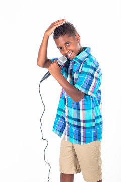Confident and Talented young diverse singer singing and performing. Cute African American boy singing with emotion and performing on stage. Isolated on a white background
