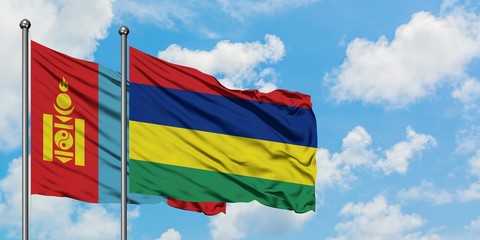 Mongolia and Mauritius flag waving in the wind against white cloudy blue sky together. Diplomacy concept, international relations.
