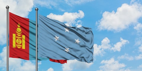 Mongolia and Micronesia flag waving in the wind against white cloudy blue sky together. Diplomacy concept, international relations.