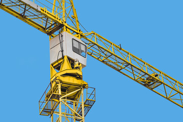 Fototapeta na wymiar Yellow crane on a blue sky background