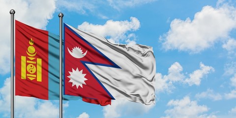 Mongolia and Nepal flag waving in the wind against white cloudy blue sky together. Diplomacy concept, international relations.