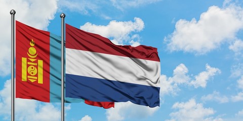 Mongolia and Netherlands flag waving in the wind against white cloudy blue sky together. Diplomacy concept, international relations.