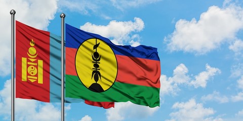 Mongolia and New Caledonia flag waving in the wind against white cloudy blue sky together. Diplomacy concept, international relations.
