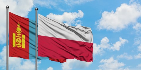 Mongolia and Poland flag waving in the wind against white cloudy blue sky together. Diplomacy concept, international relations.