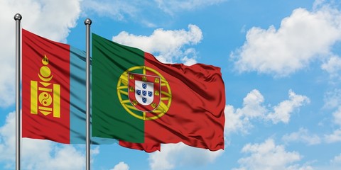 Mongolia and Portugal flag waving in the wind against white cloudy blue sky together. Diplomacy concept, international relations.