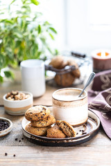 Homemade cookies with nuts and coffee in a ceramic cup
