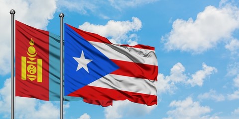 Mongolia and Puerto Rico flag waving in the wind against white cloudy blue sky together. Diplomacy concept, international relations.