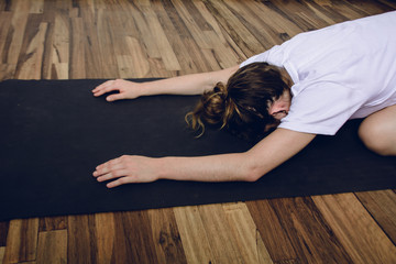 Fototapeta premium Young woman practicing yoga in home.