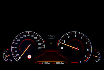 Close up shot of a red speedometer in a car. Car dashboard. Dashboard details with indication...