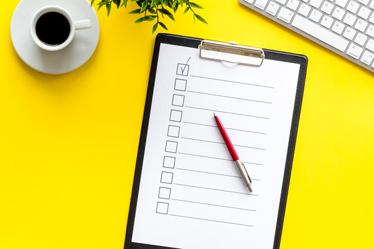 Empty check list ready to fill on yellow background top view