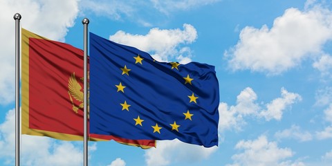 Montenegro and European Union flag waving in the wind against white cloudy blue sky together. Diplomacy concept, international relations.