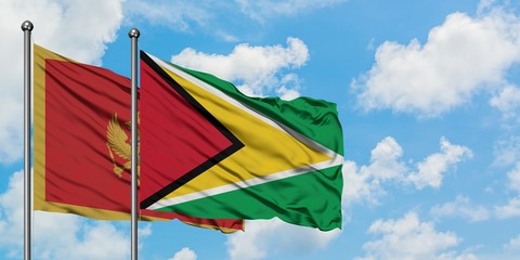 Montenegro and Guyana flag waving in the wind against white cloudy blue sky together. Diplomacy concept, international relations.