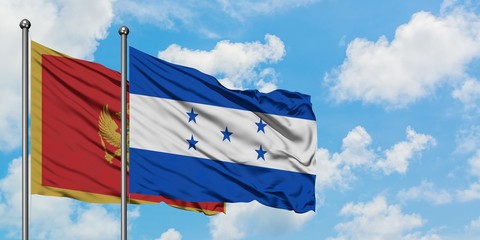 Montenegro and Honduras flag waving in the wind against white cloudy blue sky together. Diplomacy concept, international relations.
