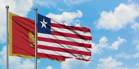 Montenegro and Liberia flag waving in the wind against white cloudy blue sky together. Diplomacy concept, international relations.