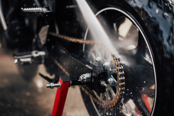 Image of high pressure cleaning of the motorcycle, close-up.
