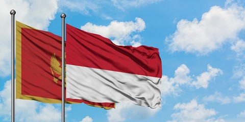Montenegro and Monaco flag waving in the wind against white cloudy blue sky together. Diplomacy concept, international relations.