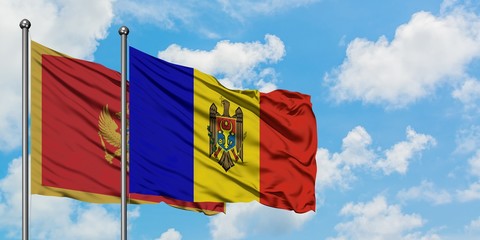 Montenegro and Moldova flag waving in the wind against white cloudy blue sky together. Diplomacy...