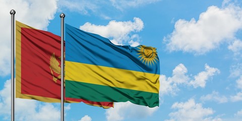 Montenegro and Rwanda flag waving in the wind against white cloudy blue sky together. Diplomacy concept, international relations.