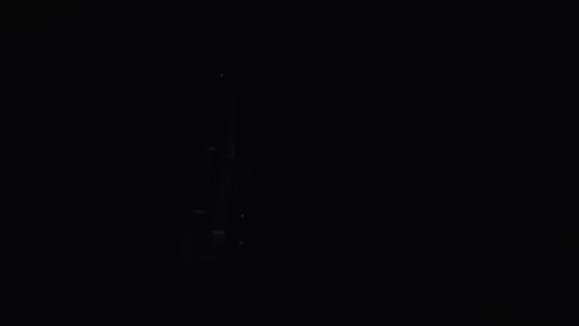 Hard drive spinning and being lighted by key light with dark background