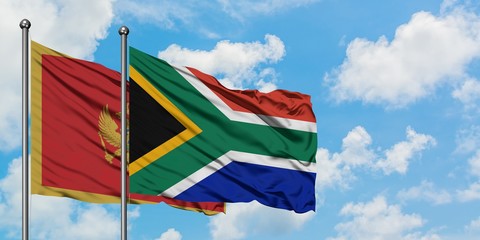 Montenegro and South Africa flag waving in the wind against white cloudy blue sky together. Diplomacy concept, international relations.