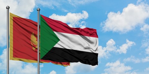 Montenegro and Sudan flag waving in the wind against white cloudy blue sky together. Diplomacy concept, international relations.