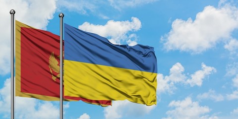 Montenegro and Ukraine flag waving in the wind against white cloudy blue sky together. Diplomacy concept, international relations.
