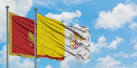 Montenegro and Vatican City flag waving in the wind against white cloudy blue sky together....