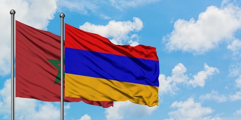 Morocco and Armenia flag waving in the wind against white cloudy blue sky together. Diplomacy concept, international relations.