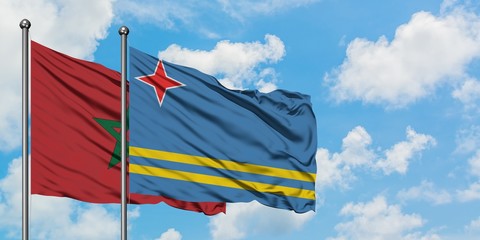 Morocco and Aruba flag waving in the wind against white cloudy blue sky together. Diplomacy concept, international relations.