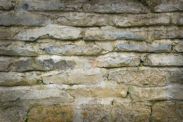 Close up of yellow vintage brick wall texture. Background of old vintage dirty brick wall with peeling plaster, texture.