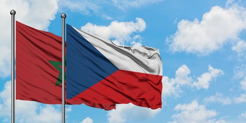 Morocco and Czech Republic flag waving in the wind against white cloudy blue sky together....