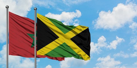 Morocco and Jamaica flag waving in the wind against white cloudy blue sky together. Diplomacy concept, international relations.