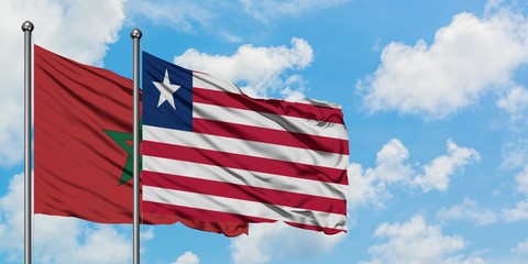 Morocco and Liberia flag waving in the wind against white cloudy blue sky together. Diplomacy concept, international relations.