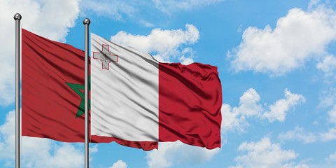 Morocco and Malta flag waving in the wind against white cloudy blue sky together. Diplomacy concept, international relations.