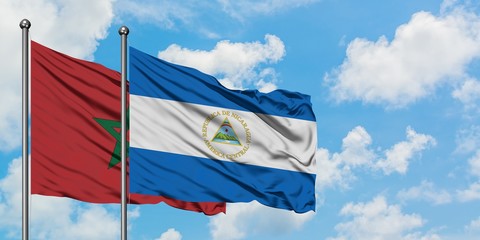 Morocco and Nicaragua flag waving in the wind against white cloudy blue sky together. Diplomacy concept, international relations.