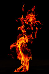 Fire flame isolated on black background. Beautiful scraps of fire.