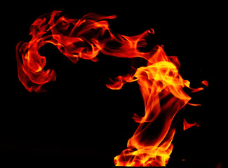 Fototapeta premium Fire flame isolated on black background. Shaman on fire.
