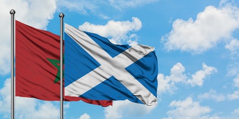 Morocco and Scotland flag waving in the wind against white cloudy blue sky together. Diplomacy concept, international relations.
