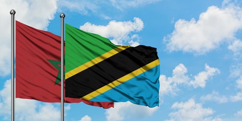 Morocco and Tanzania flag waving in the wind against white cloudy blue sky together. Diplomacy concept, international relations.