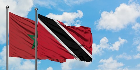 Morocco and Trinidad And Tobago flag waving in the wind against white cloudy blue sky together. Diplomacy concept, international relations.