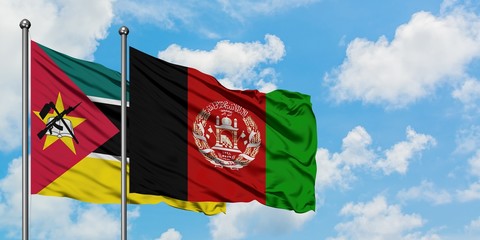Mozambique and Afghanistan flag waving in the wind against white cloudy blue sky together....