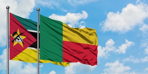 Mozambique and Benin flag waving in the wind against white cloudy blue sky together. Diplomacy concept, international relations.