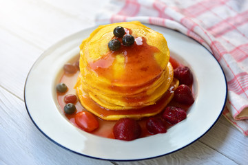 Close up Healthy summer breakfast,homemade classic american pancakes with fresh berry and honey, morning light grey stone background copy space top view