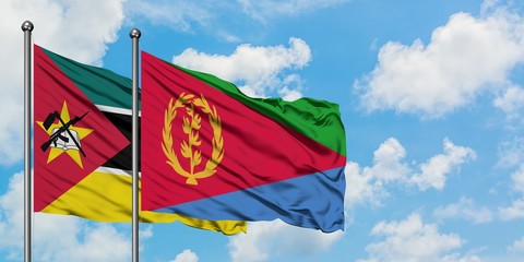 Mozambique and Eritrea flag waving in the wind against white cloudy blue sky together. Diplomacy concept, international relations.