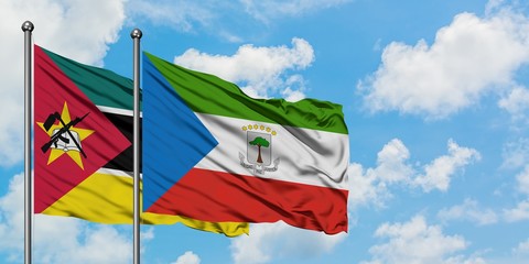 Mozambique and Equatorial Guinea flag waving in the wind against white cloudy blue sky together. Diplomacy concept, international relations.