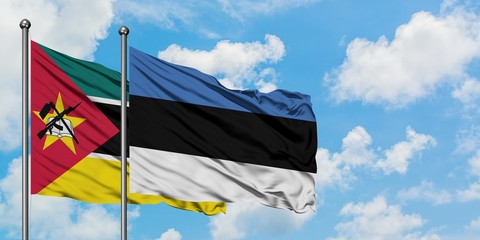Mozambique and Estonia flag waving in the wind against white cloudy blue sky together. Diplomacy concept, international relations.